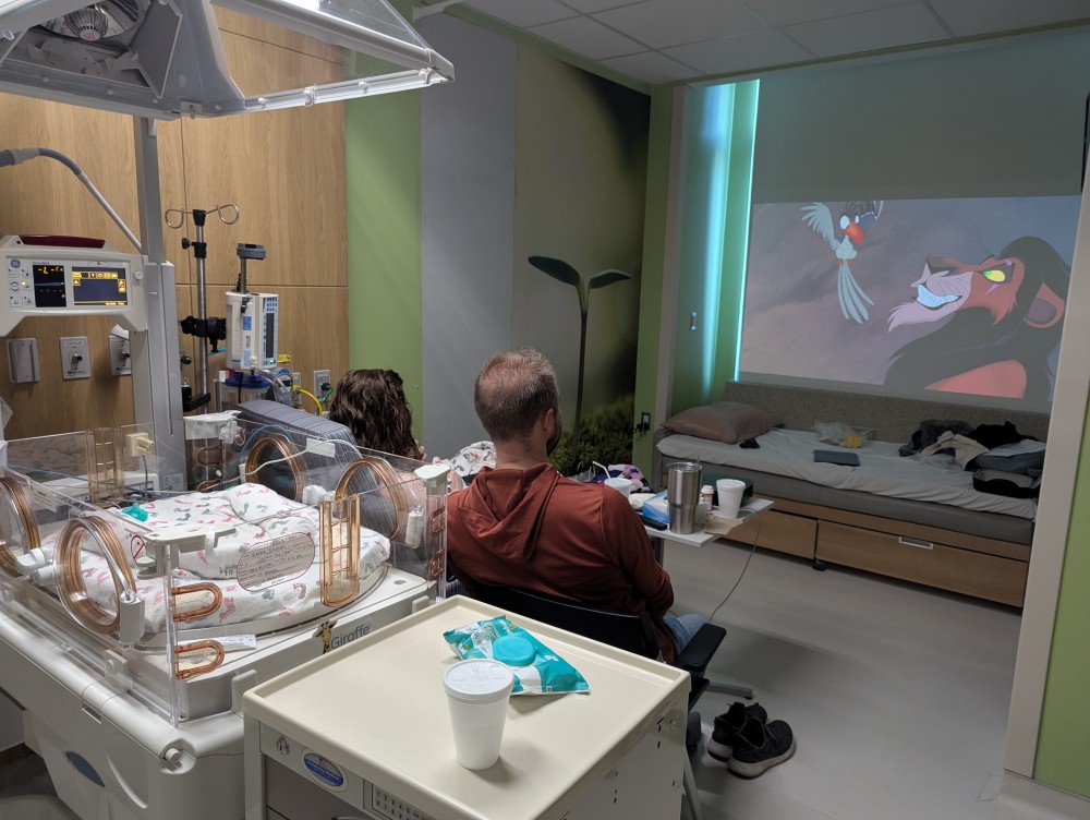 a family watching a movie in the NICU