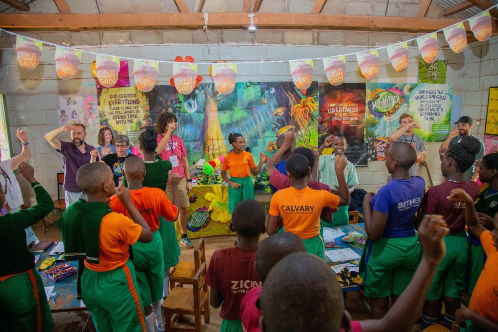 a group of Americans lead a song for children in Africa