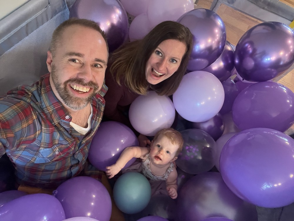 a family in a pit of balloons