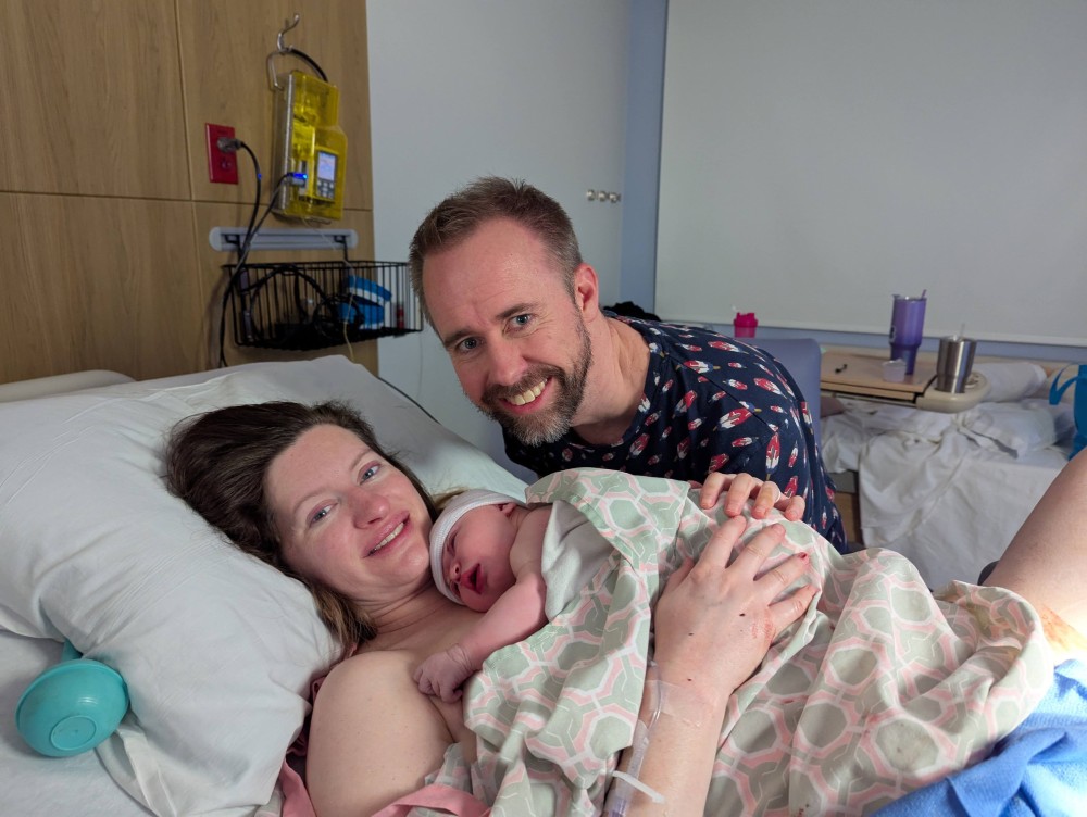 Shane Reichart and Amanda Reichart holding Vienna Reichart in the delivery room