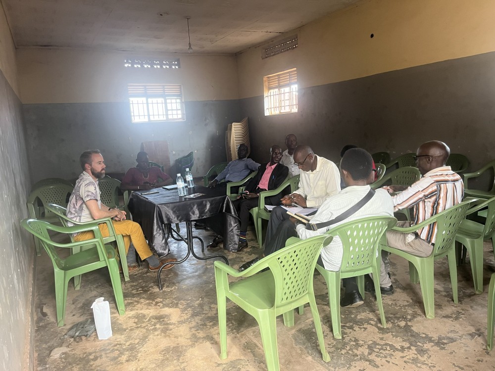 an American man seated in a circle with African men
